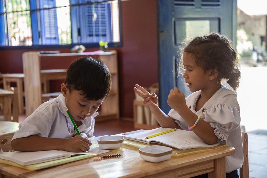 Pupils working on their notebooks at Bayon School