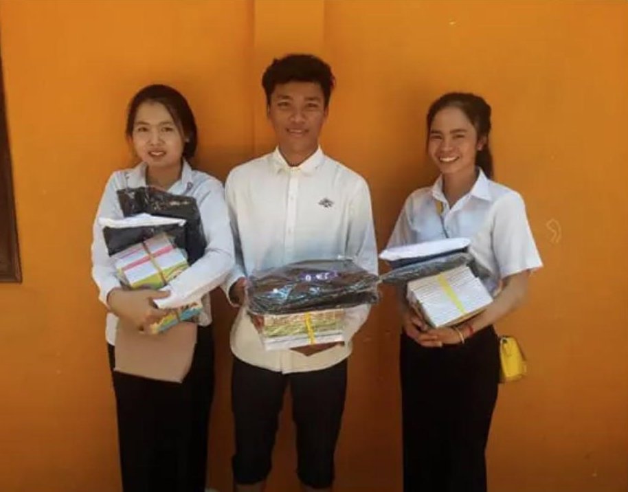 Students at Bayon School, Cambodia, receiving school supplies
