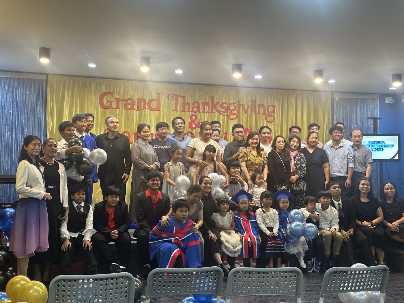 Students, teachers and families gather for a group photo