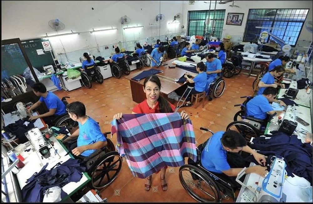 Residents with disabilities sewing at the Take Wing vocational training center